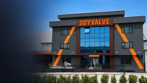 SOYVALVE factory entrance with orange aluminum box letters above the glass façade.