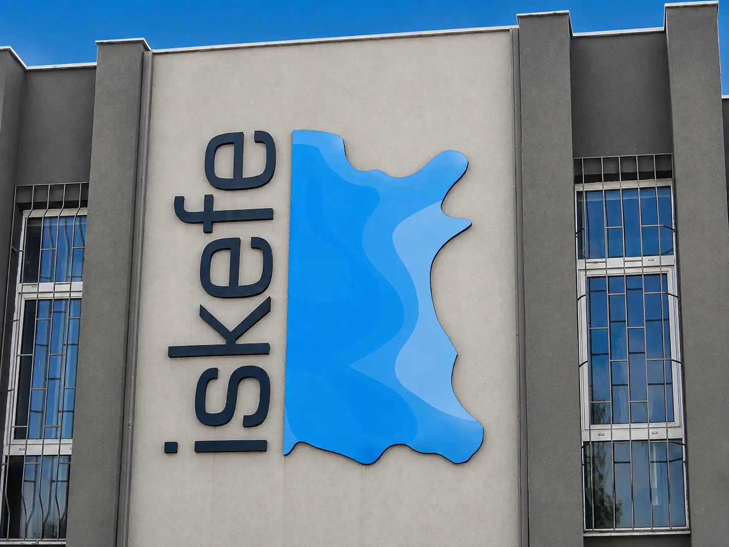 Close-up of the blue İskefe emblem and vertical lettering on the building façade