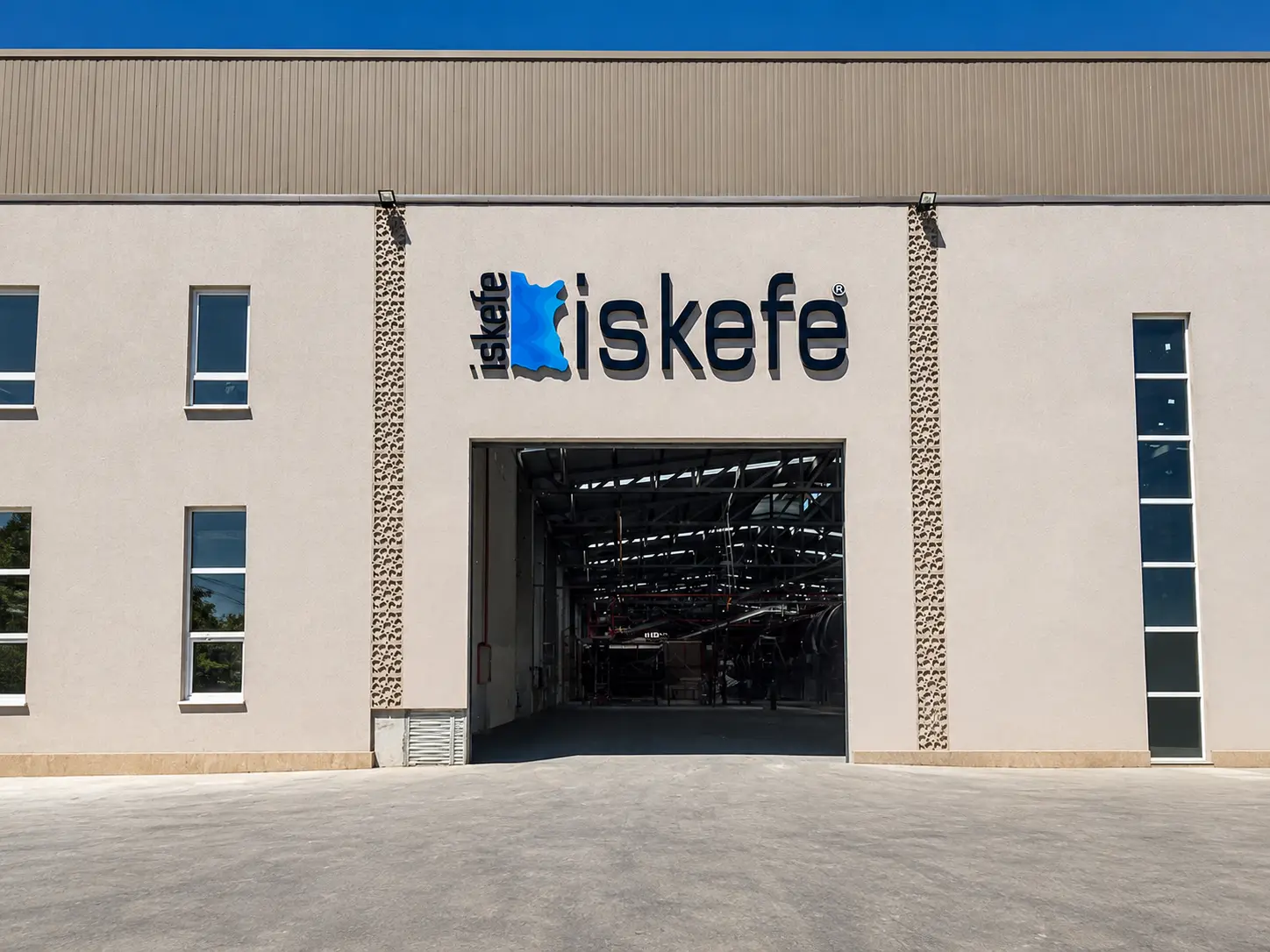 Front elevation of the İskefe industrial building with logo signage above the entrance