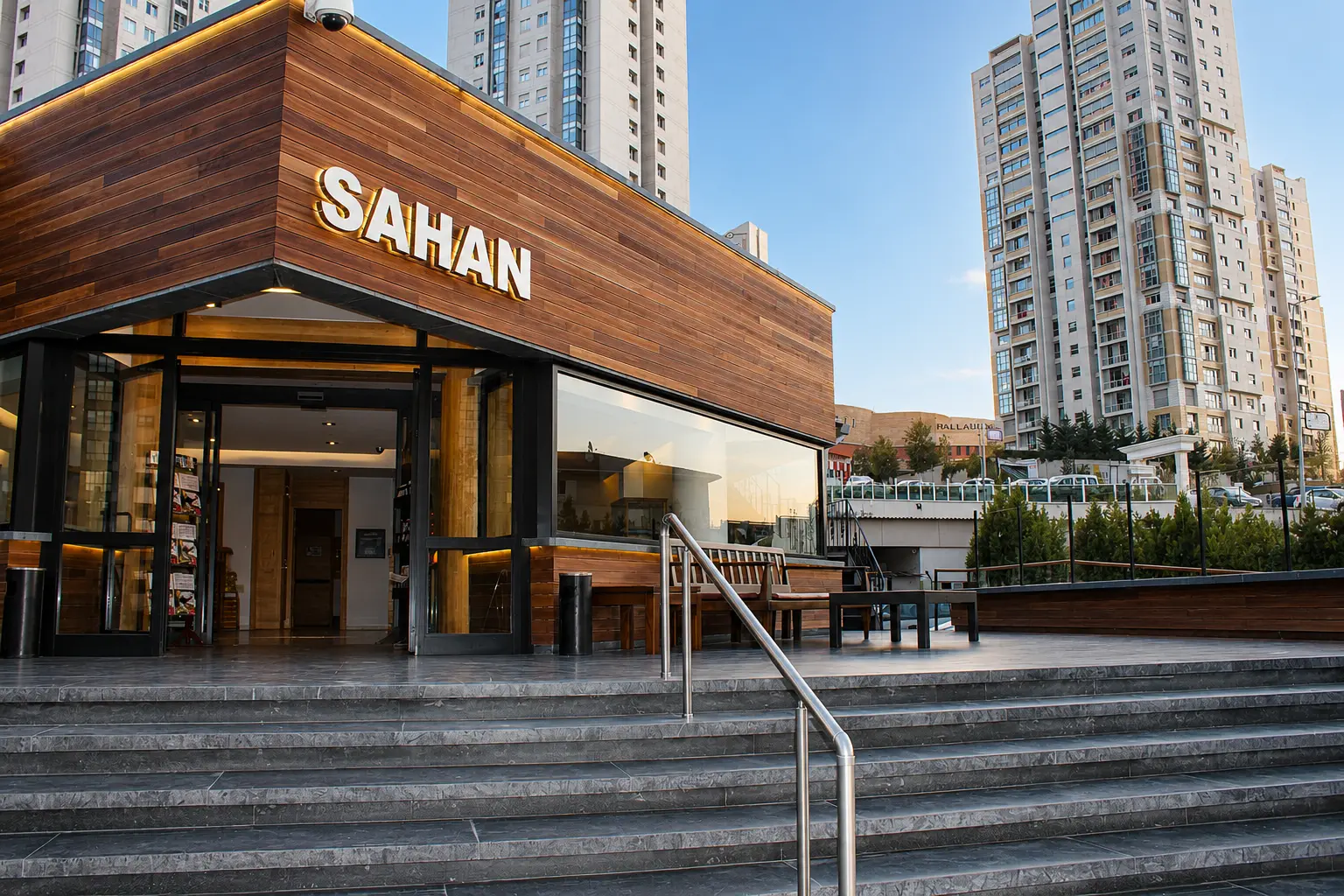 Sahan restaurant entrance with halo-lit lettering on the wood-clad façade