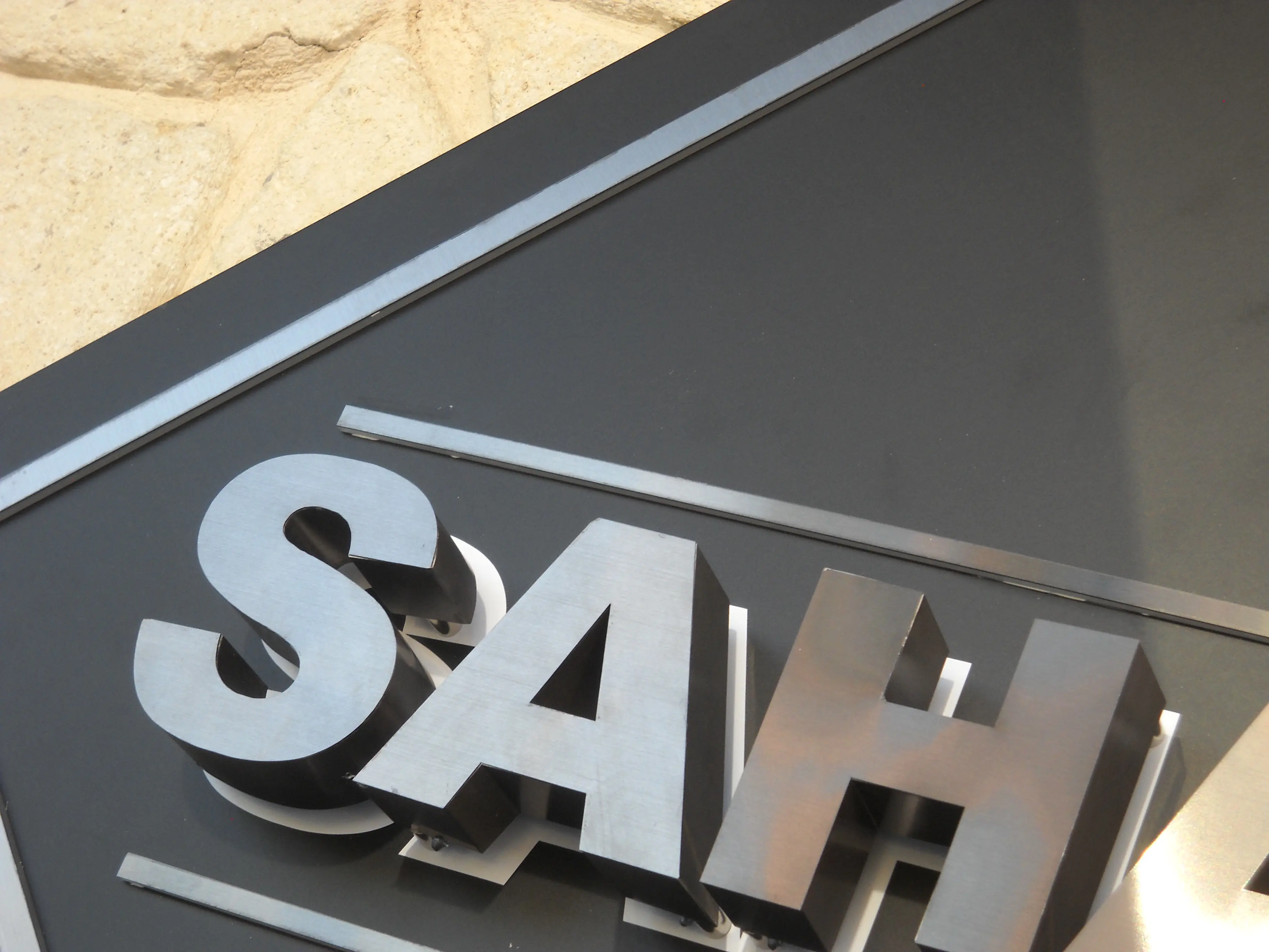 Close-up of dimensional stainless steel SAHAN letters