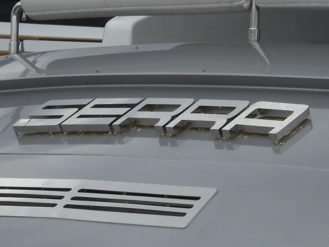 Close-up of SERRA stainless steel letters and their subtle halo lighting on the yacht