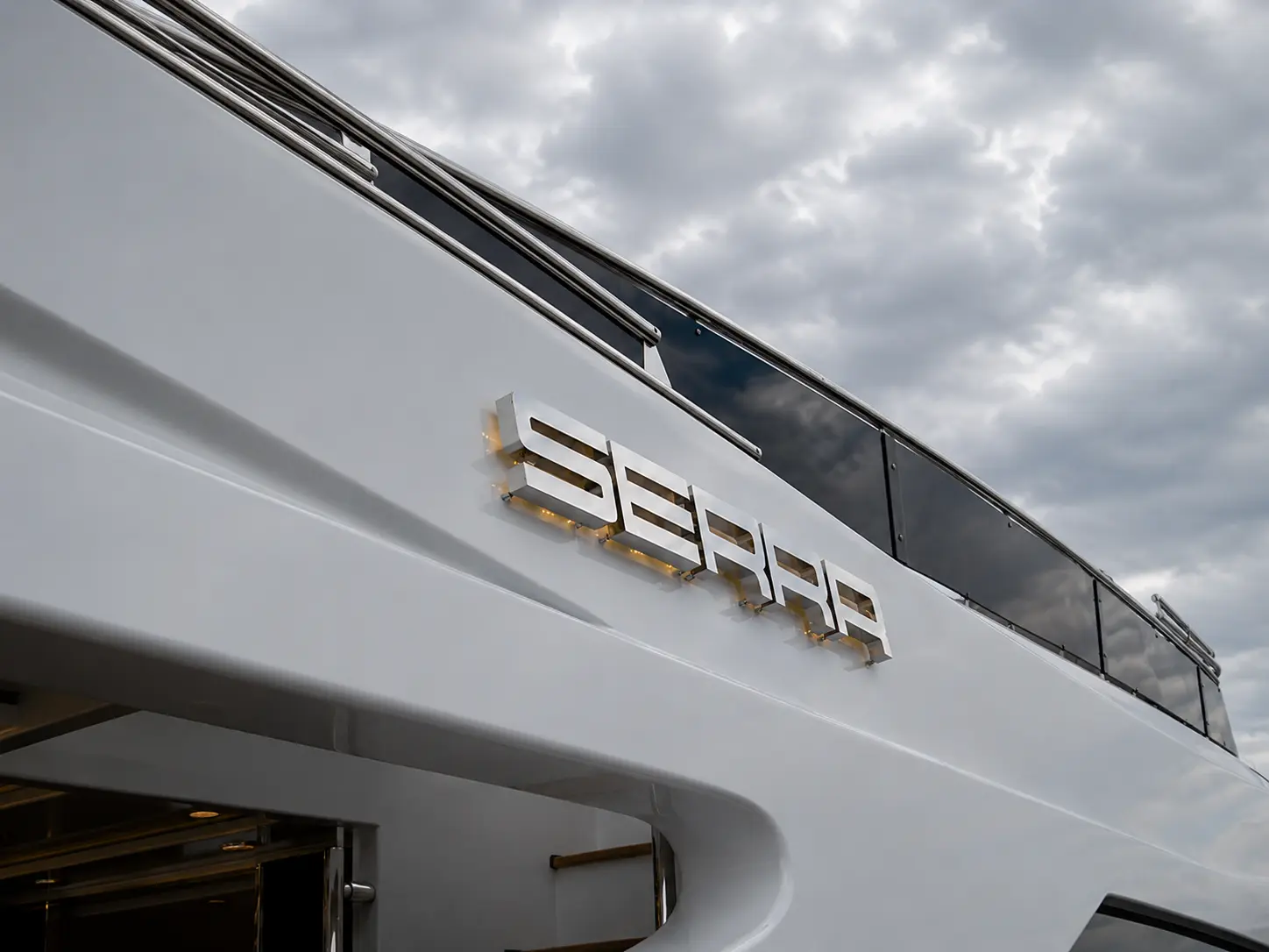 Halo-lit stainless steel SERRA letters mounted on the side of a white yacht