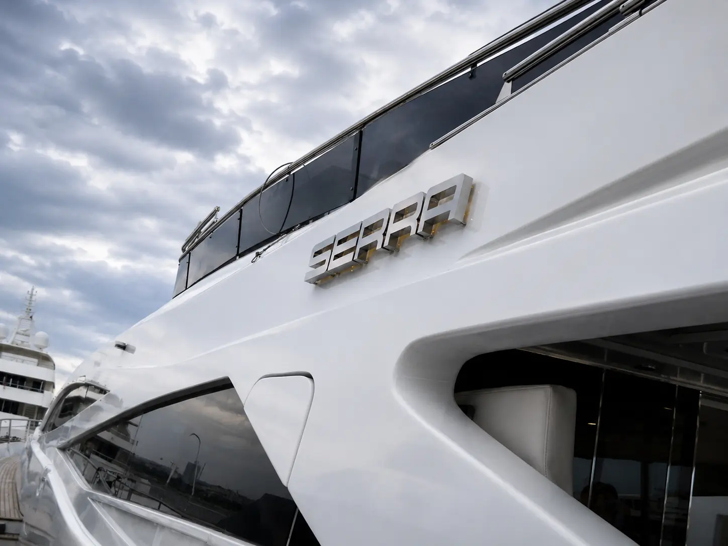 Wide view of the SERRA stainless steel lettering on the yacht’s white exterior