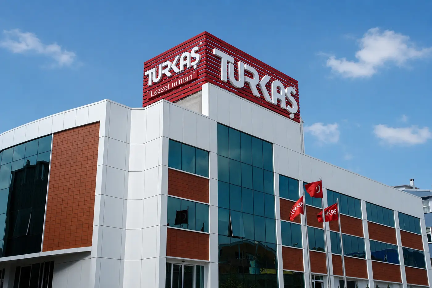 Daytime view of the Turkaş building and its two-sided rooftop sign