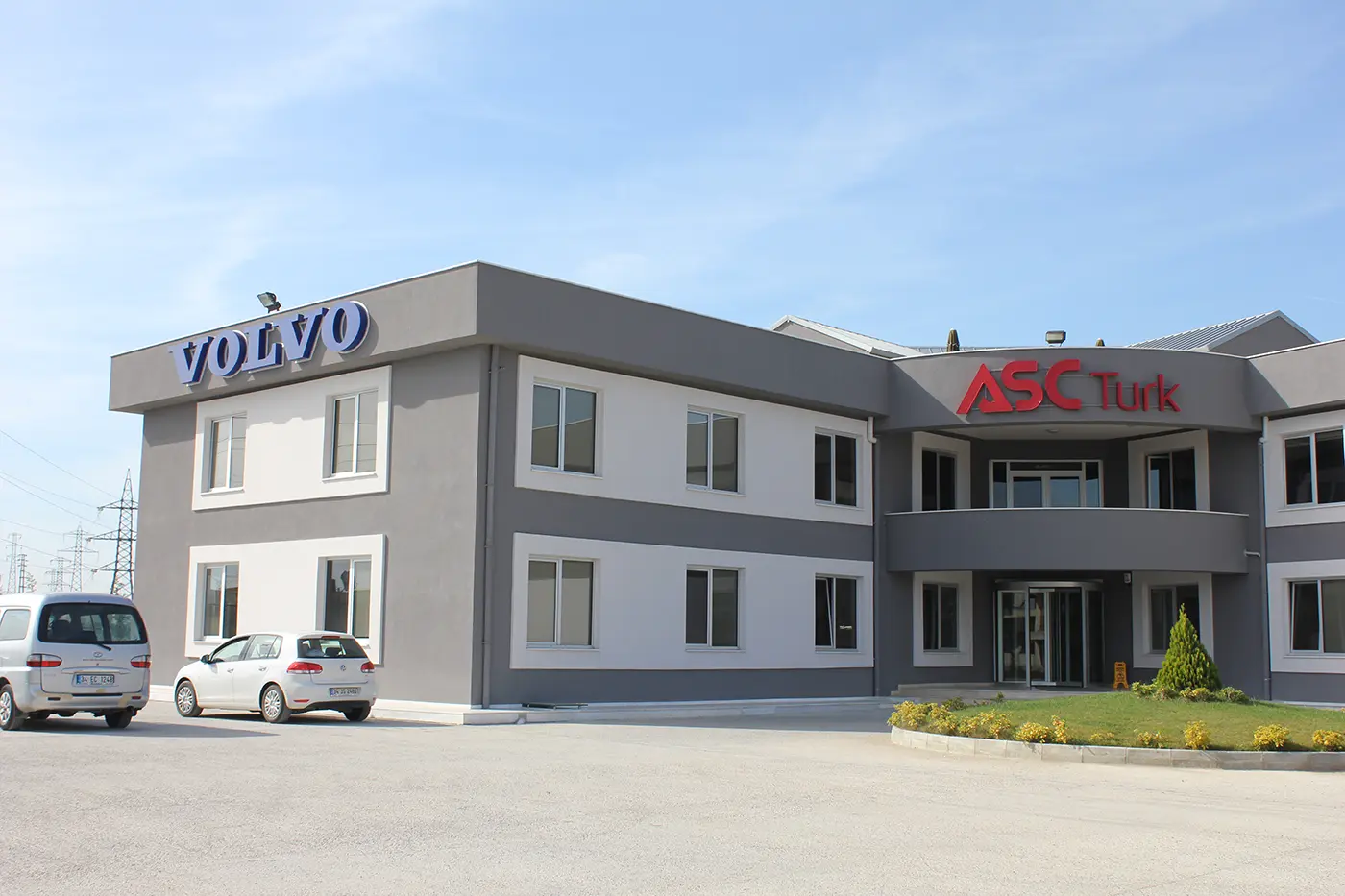 Building exterior with blue VOLVO aluminum letters above the left wing