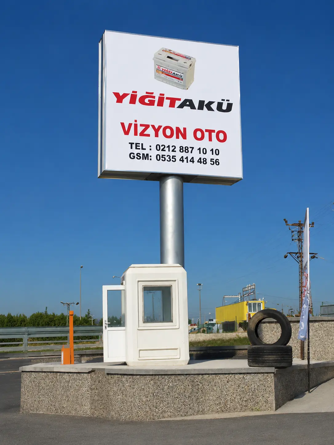 Completed Yiğit Akü and Vizyon Oto pylon sign beside the roadside entrance