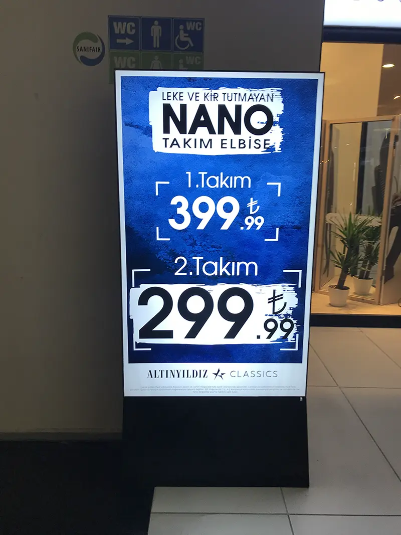 Altınyıldız Classics freestanding illuminated promotional display with a black base