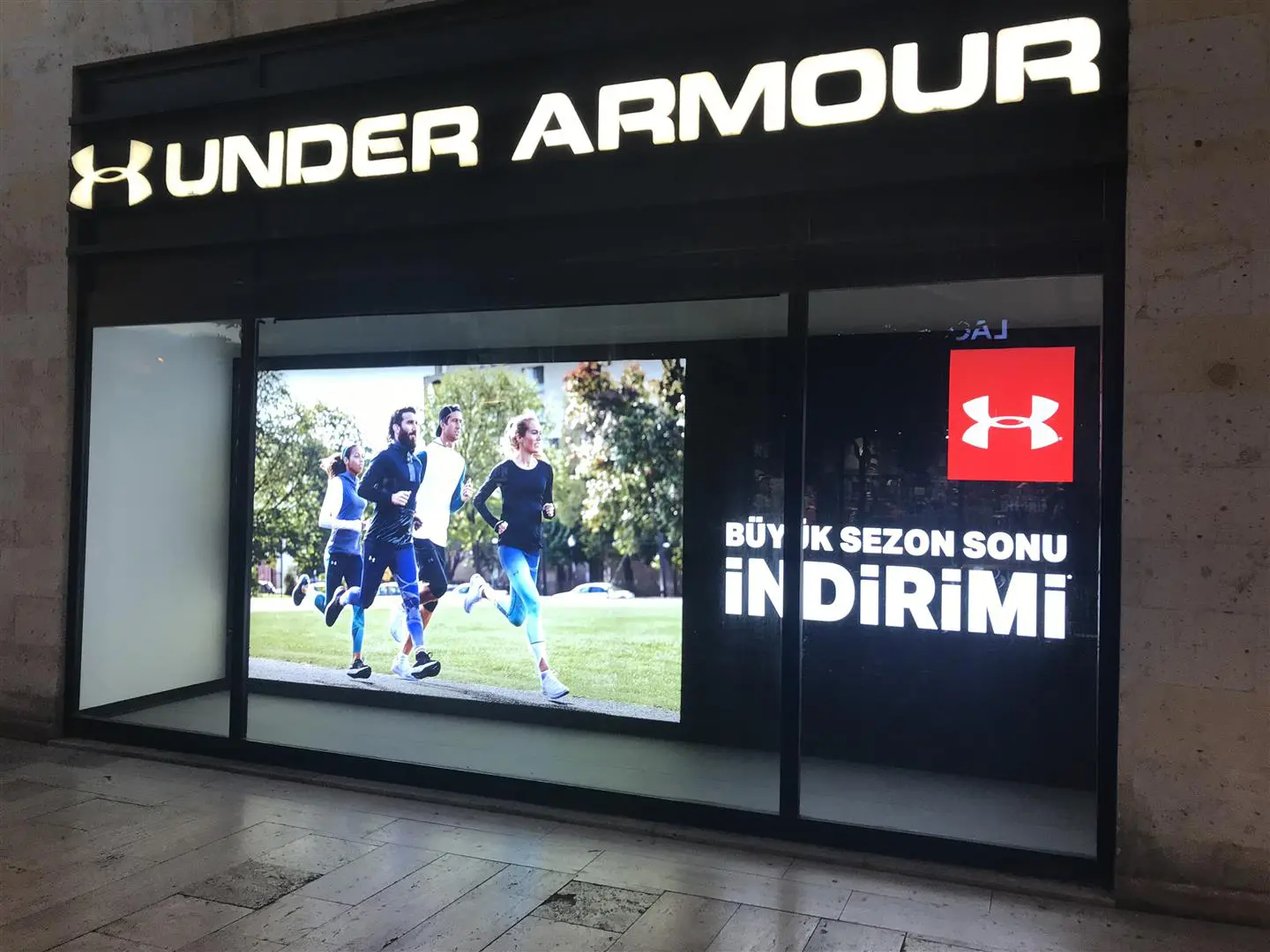 Backlit retail graphics and illuminated display for an Under Armour storefront