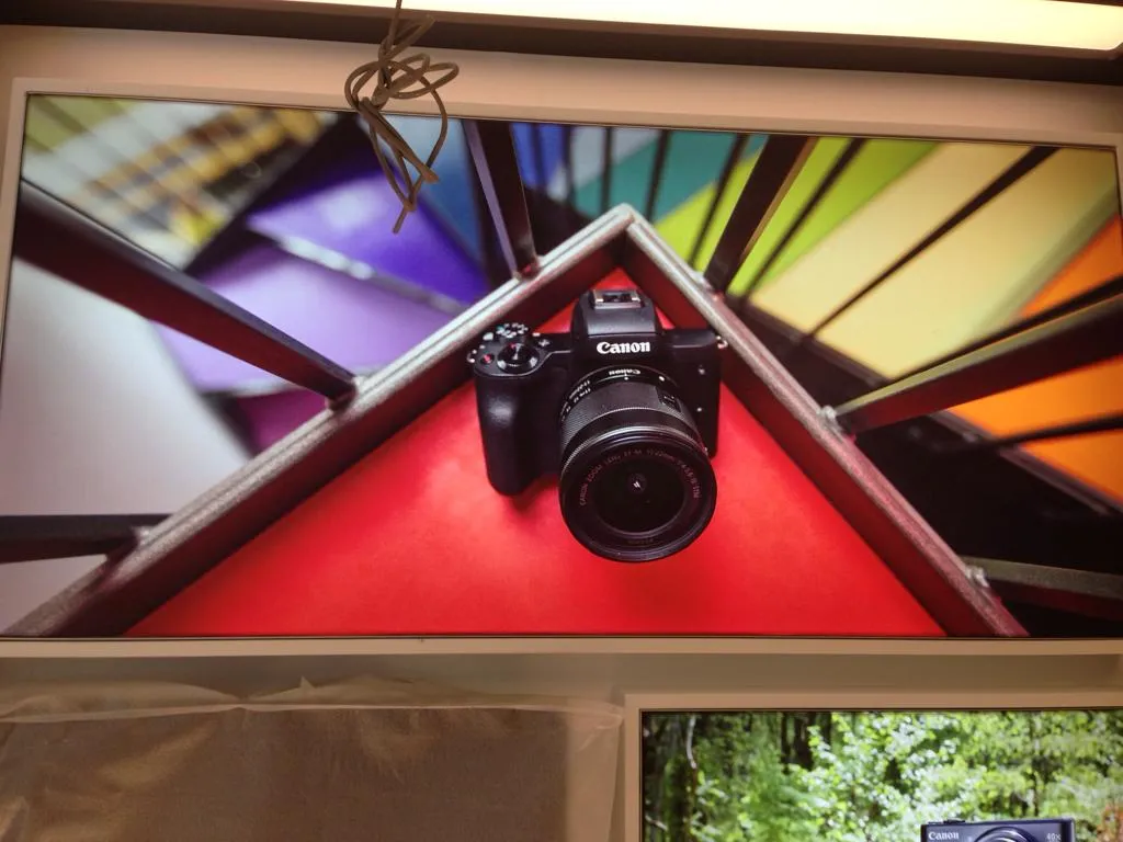Backlit Canon camera graphic installed above the product display area at the Sirkeci store