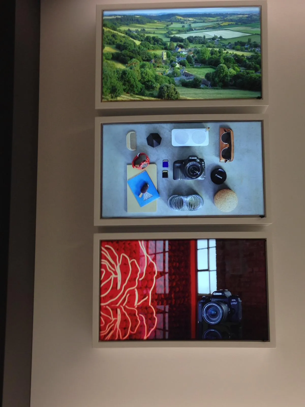 Close-up of illuminated photography display panels featuring Canon cameras inside the Sirkeci store