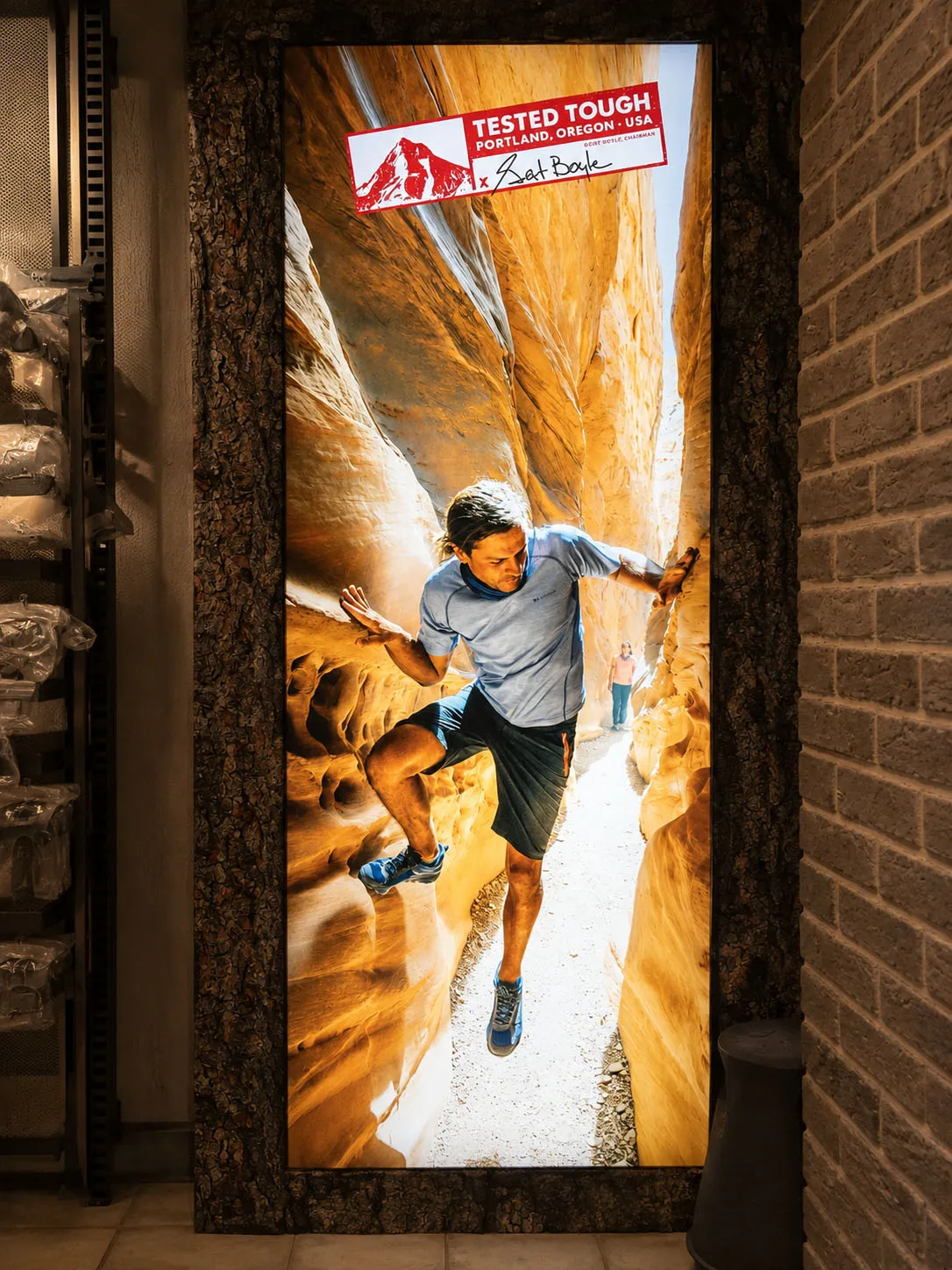 Vertical Columbia Tested Tough lightbox featuring a runner inside a canyon
