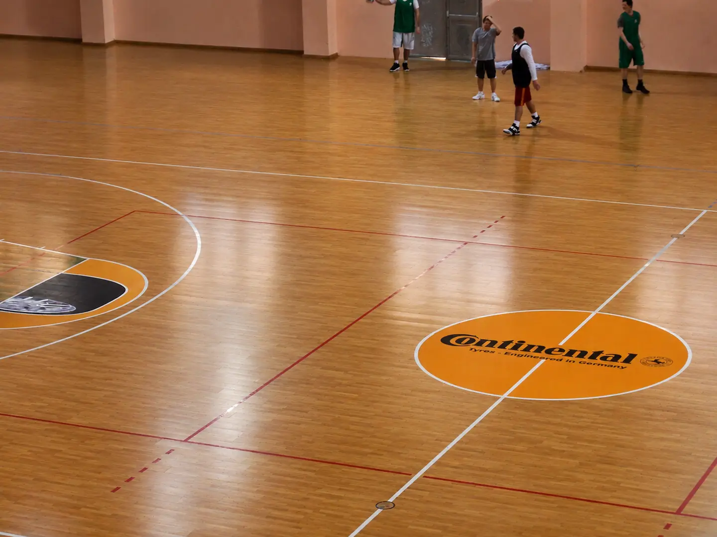 Custom Continental floor graphics applied to an indoor sports court