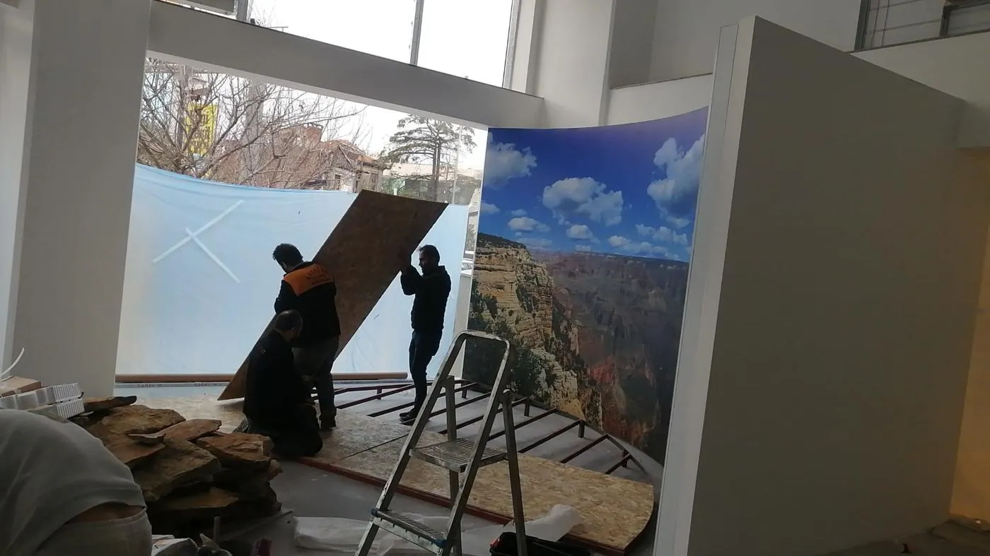 Installation team assembling a curved scenic display inside a Honda dealership