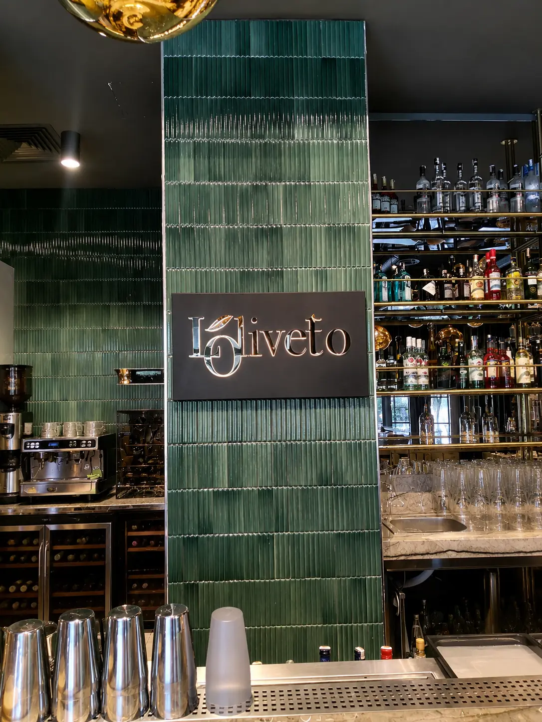 Gold Loliveto logo on a dark panel inside the restaurant