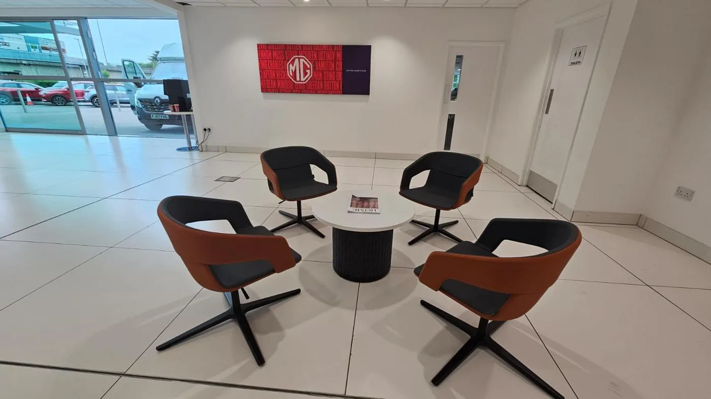 MG heritage campaign wall lightbox installed in a UK dealership customer lounge