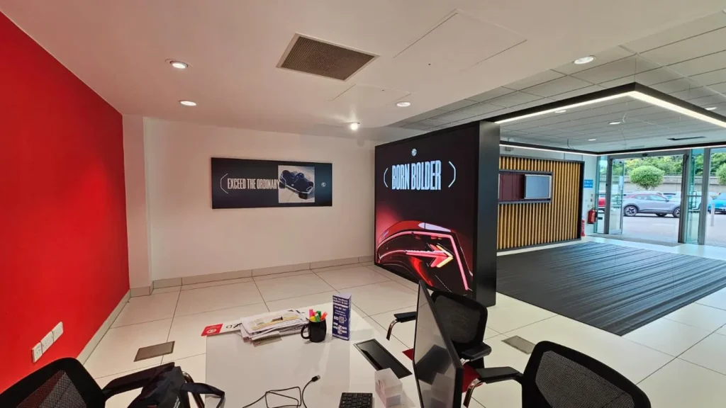 Backlit MG campaign displays installed inside a UK dealership reception area