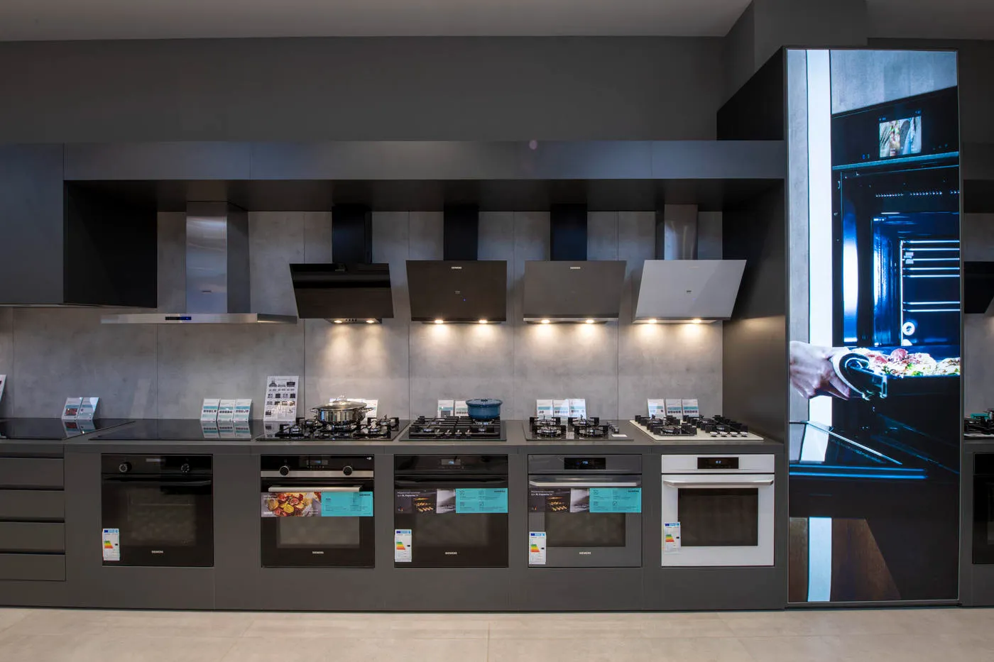 Siemens oven, hob and cooker hood product wall with vertical digital campaign display