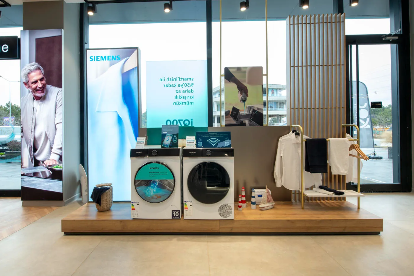 Siemens washing machine and dryer retail display with illuminated campaign graphics and lifestyle styling