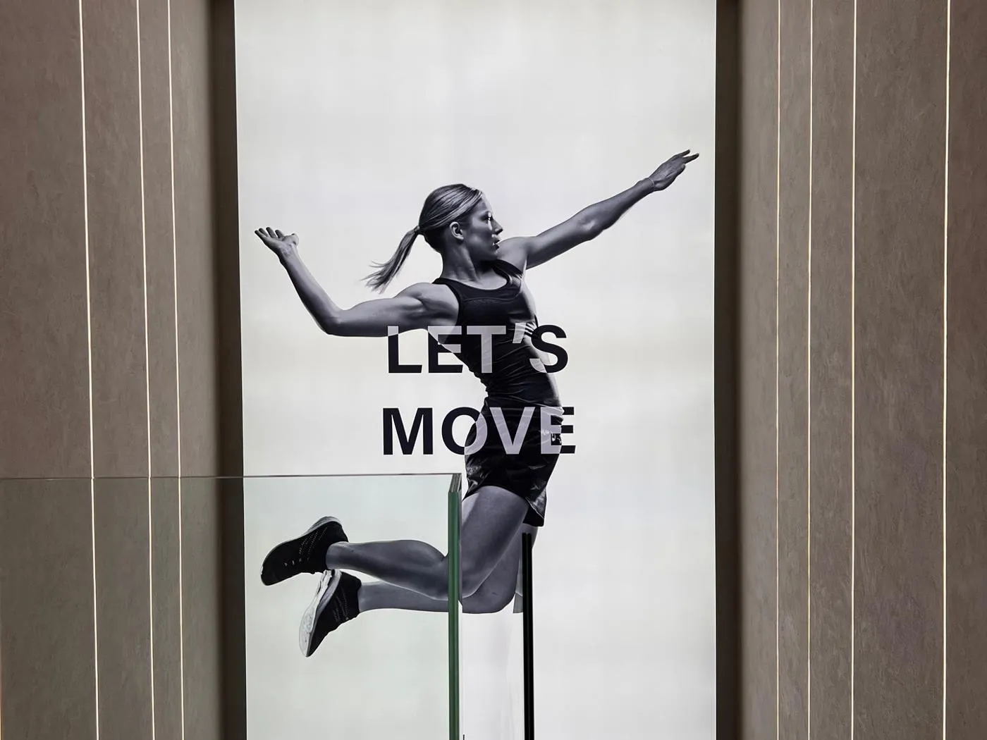 Technogym illuminated wall graphic with athlete and Let's Move message