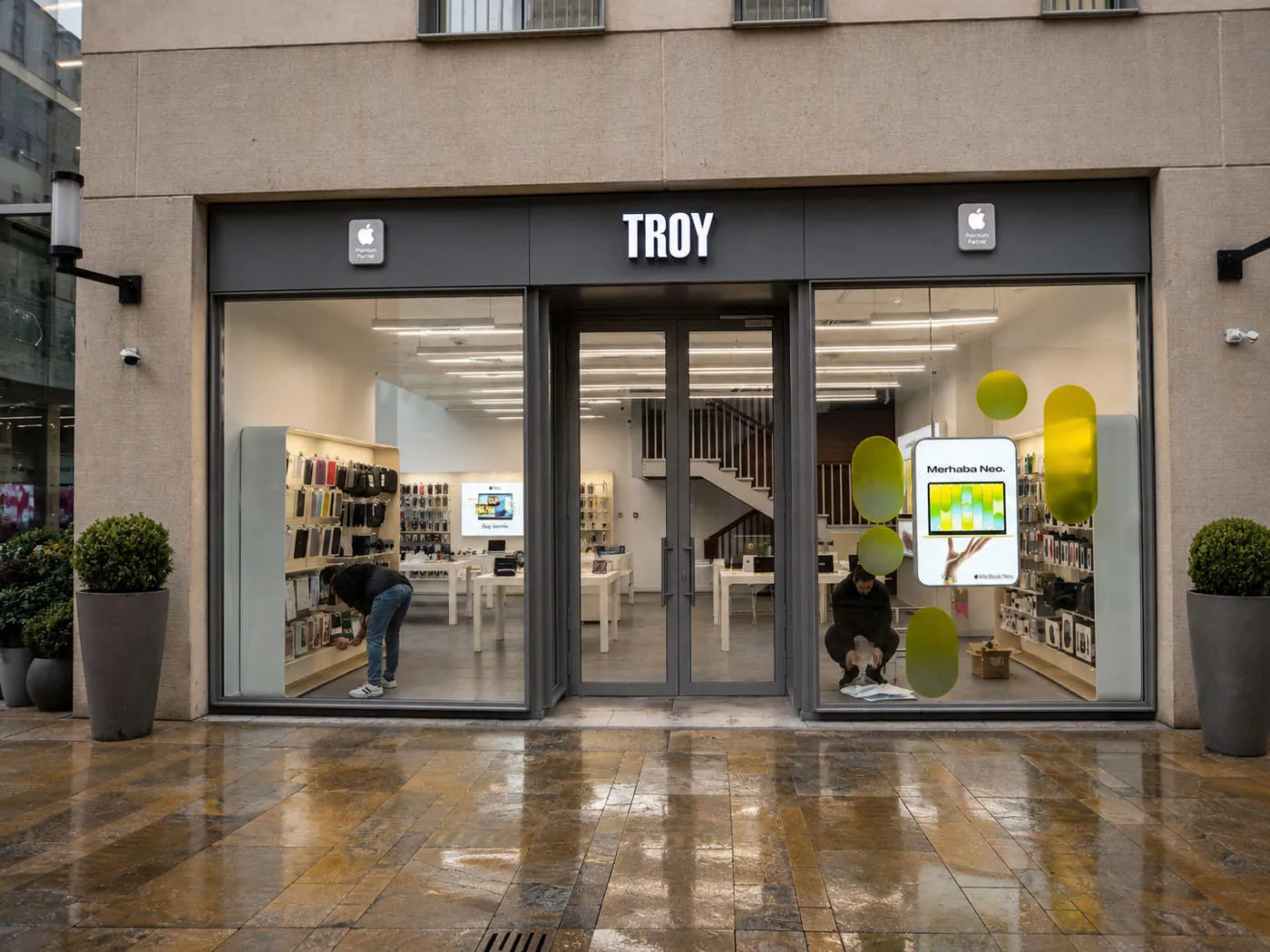 TROY Apple Premium Partner storefront with MacBook Neo window graphics during installation